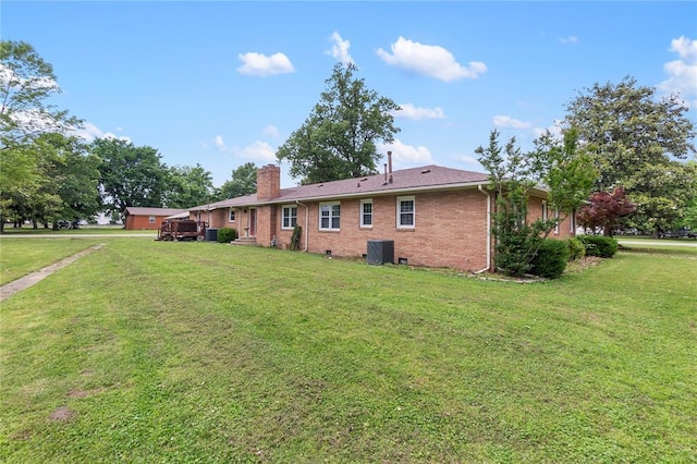 102 E Charlotte, Lilbourn, MO 63862 - back of house with central AC unit, a chimney, a yard, and brick siding