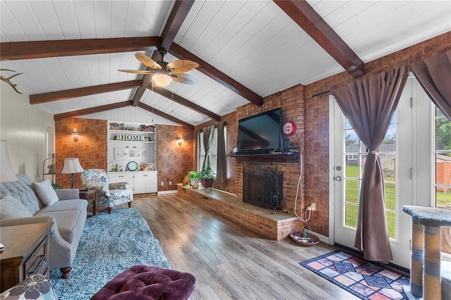 102 E Charlotte, Lilbourn, MO 63862 - living room with wood finished floors, a ceiling fan, a fireplace, brick wall, and baseboards