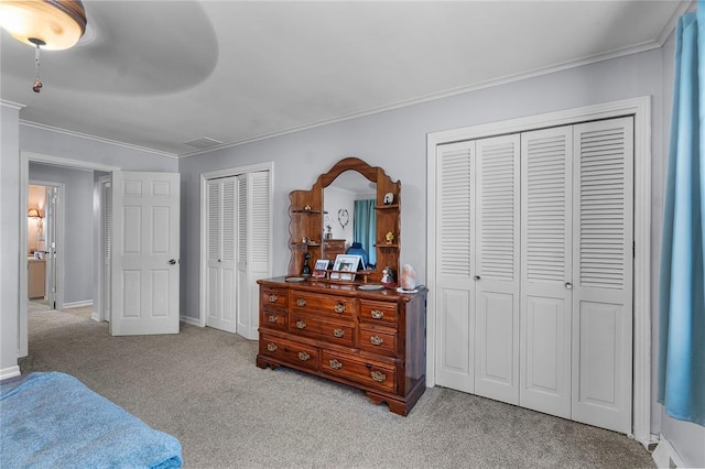 102 E Charlotte, Lilbourn, MO 63862 - bedroom with multiple closets, carpet, crown molding, ceiling fan, and baseboards