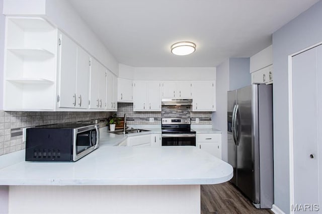 10077 N Bunker Hill Dr Unit F, Mehlville, MO 63123 - kitchen with stainless steel appliances, under cabinet range hood, open shelves, dark wood-type flooring, and decorative backsplash