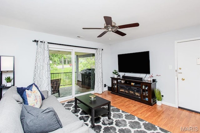 10077 N Bunker Hill Dr Unit F, Mehlville, MO 63123 - living room featuring wood finished floors and a ceiling fan