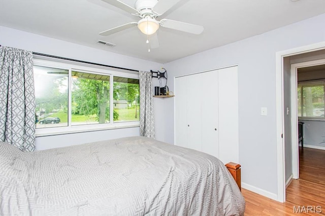 10077 N Bunker Hill Dr Unit F, Mehlville, MO 63123 - bedroom with wood finished floors, a closet, and ceiling fan