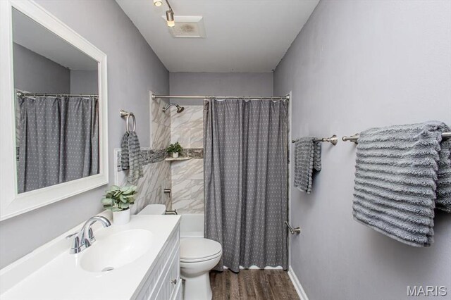 10077 N Bunker Hill Dr Unit F, Mehlville, MO 63123 - bathroom with wood finished floors, vanity, and shower / tub combo with curtain