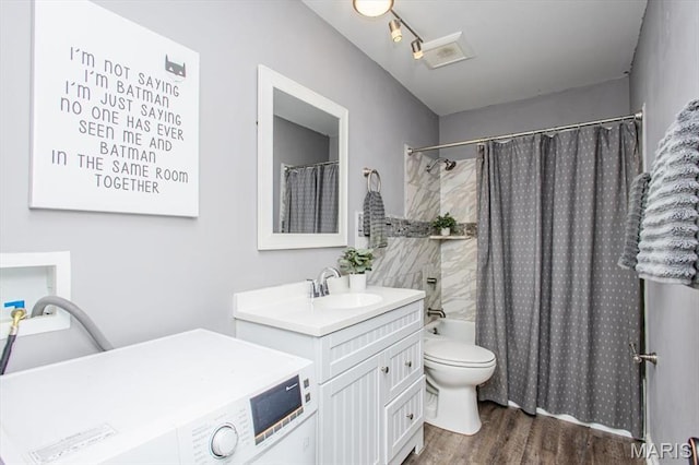 10077 N Bunker Hill Dr Unit F, Mehlville, MO 63123 - full bath with washer / dryer, vanity, wood finished floors, and shower / bath combo with shower curtain