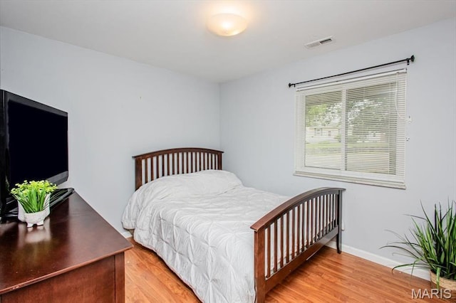 10077 N Bunker Hill Dr Unit F, Mehlville, MO 63123 - bedroom with light wood-style floors