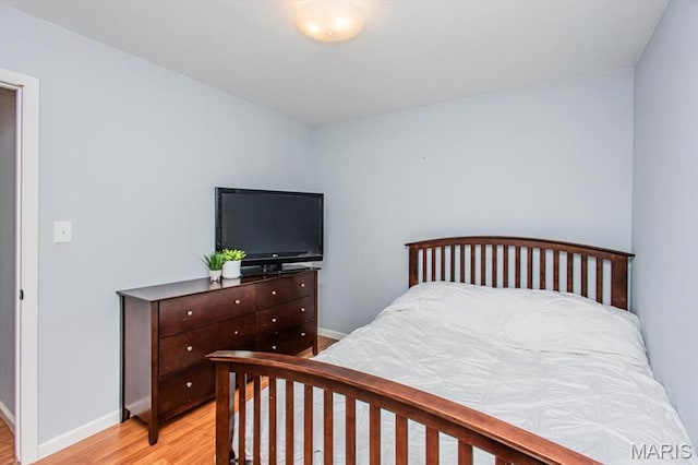10077 N Bunker Hill Dr Unit F, Mehlville, MO 63123 - bedroom with light wood-style floors and baseboards