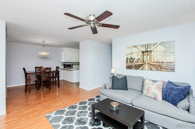 10077 N Bunker Hill Dr Unit F, Mehlville, MO 63123 - living area featuring light wood-type flooring and a ceiling fan