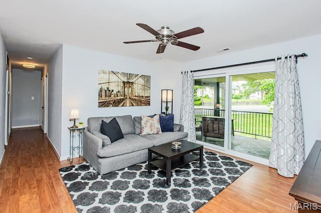 10077 N Bunker Hill Dr Unit F, Mehlville, MO 63123 - living area featuring wood finished floors and ceiling fan