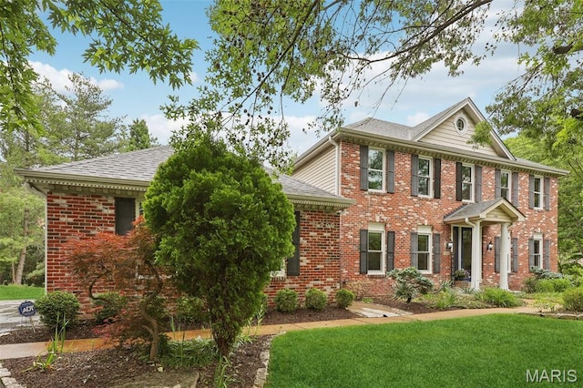200 Hibler Oaks Dr, Creve Coeur, MO 63141 - colonial-style house featuring brick siding, a front yard, and a shingled roof