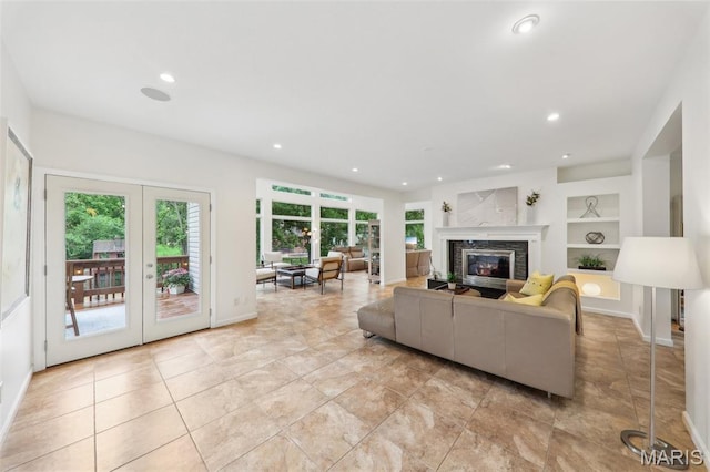 200 Hibler Oaks Dr, Creve Coeur, MO 63141 - living area with built in features, recessed lighting, a high end fireplace, french doors, and baseboards