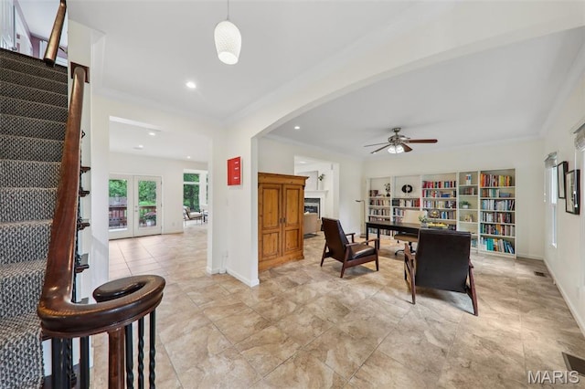 200 Hibler Oaks Dr, Creve Coeur, MO 63141 - living room with ornamental molding, a ceiling fan, baseboards, arched walkways, and french doors