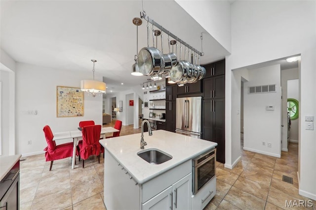 200 Hibler Oaks Dr, Creve Coeur, MO 63141 - kitchen with stainless steel appliances, a sink, pendant lighting, an island with sink, and baseboards