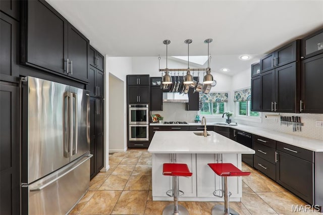 200 Hibler Oaks Dr, Creve Coeur, MO 63141 - kitchen featuring stainless steel appliances, light countertops, decorative backsplash, a sink, and recessed lighting