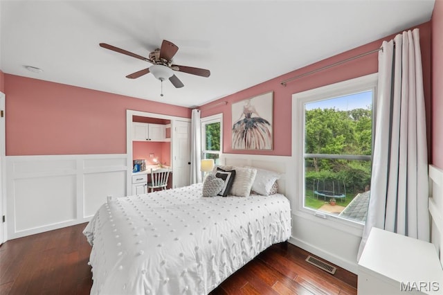 200 Hibler Oaks Dr, Creve Coeur, MO 63141 - bedroom with dark wood-style floors, wainscoting, and a ceiling fan