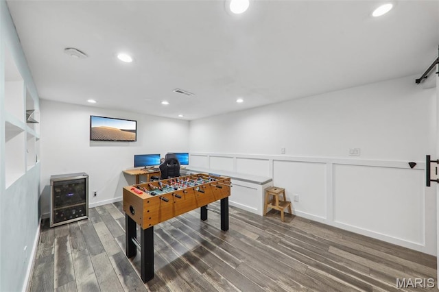 200 Hibler Oaks Dr, Creve Coeur, MO 63141 - rec room with a desk, wood finished floors, wainscoting, beverage cooler, and recessed lighting
