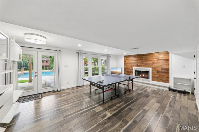 200 Hibler Oaks Dr, Creve Coeur, MO 63141 - recreation room with french doors, wood finished floors, a lit fireplace, recessed lighting, and baseboards