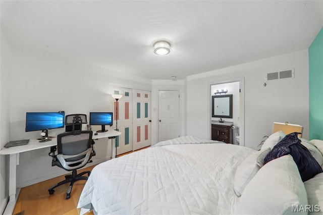 200 Hibler Oaks Dr, Creve Coeur, MO 63141 - bedroom featuring wood finished floors, an office area, a sink, connected bathroom, and a closet