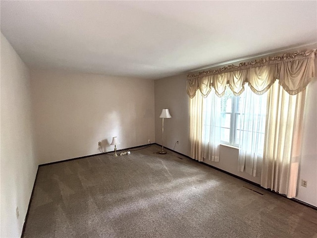 spare room with carpet flooring and baseboards