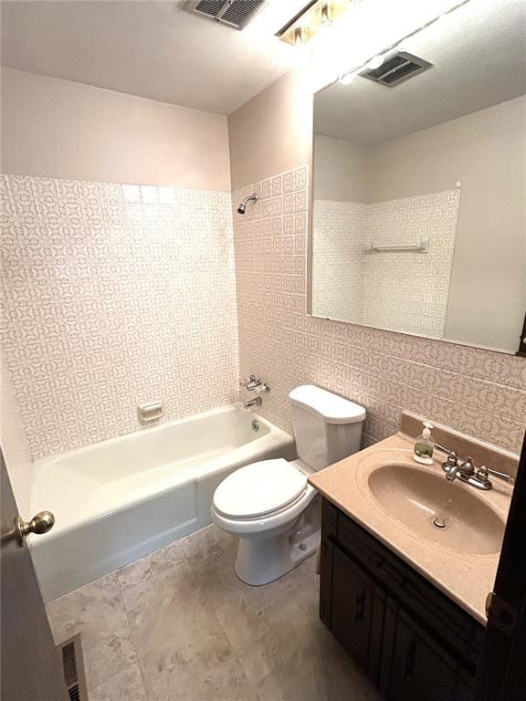 bathroom featuring bathing tub / shower combination, toilet, and vanity