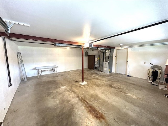 garage with gas water heater and heating unit