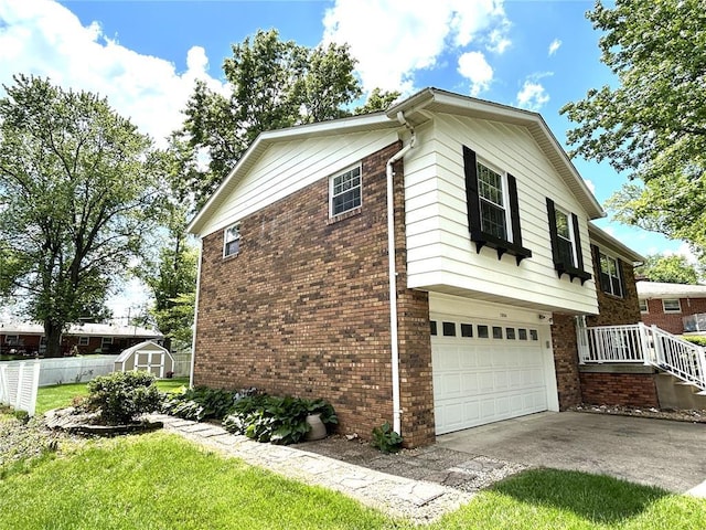 view of property exterior featuring a garage, a shed, driveway, and brick siding