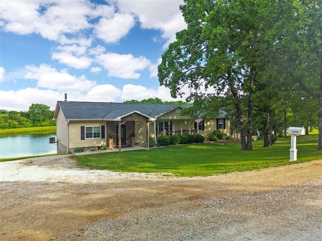 12930 Mohawk Dr, De Soto, MO 63020 - single story home with driveway, a water view, and a front lawn