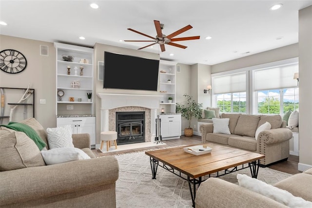12930 Mohawk Dr, De Soto, MO 63020 - living room featuring a ceiling fan, recessed lighting, light wood-style flooring, and a glass covered fireplace