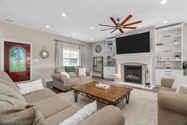 12930 Mohawk Dr, De Soto, MO 63020 - living room featuring a ceiling fan, recessed lighting, light wood-type flooring, baseboards, and a glass covered fireplace
