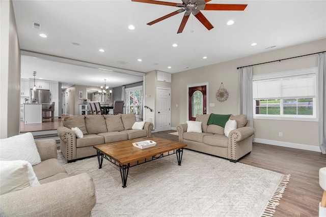 12930 Mohawk Dr, De Soto, MO 63020 - living room with a ceiling fan, light wood-style flooring, a chandelier, baseboards, and recessed lighting