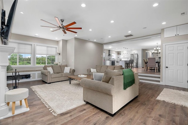 12930 Mohawk Dr, De Soto, MO 63020 - living room featuring wood finished floors, recessed lighting, ceiling fan, and a chandelier