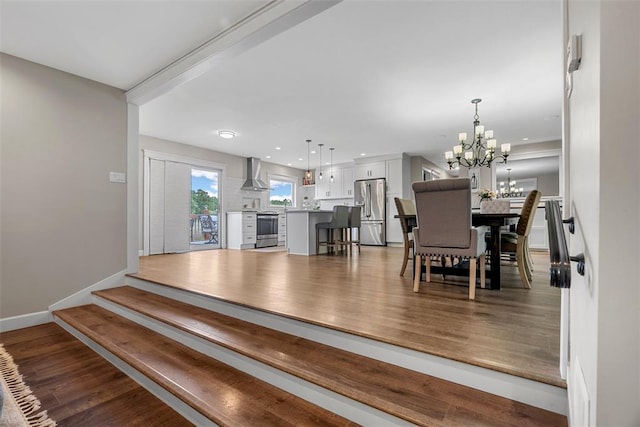 12930 Mohawk Dr, De Soto, MO 63020 - dining area featuring a chandelier, wood finished floors, baseboards, and recessed lighting