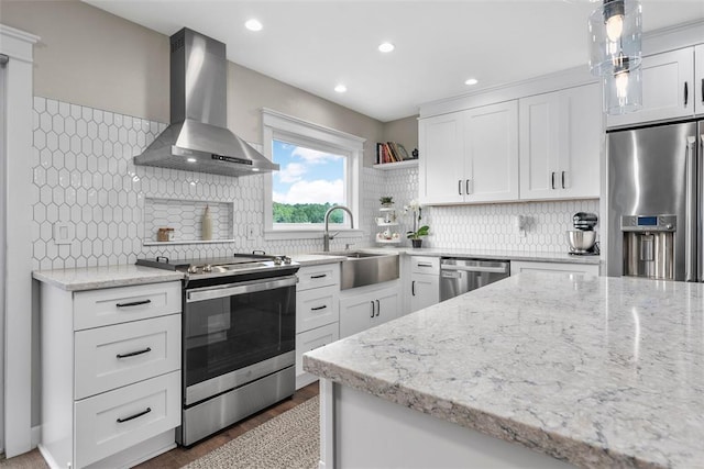 12930 Mohawk Dr, De Soto, MO 63020 - kitchen featuring wall chimney exhaust hood, stainless steel appliances, a sink, white cabinets, and recessed lighting