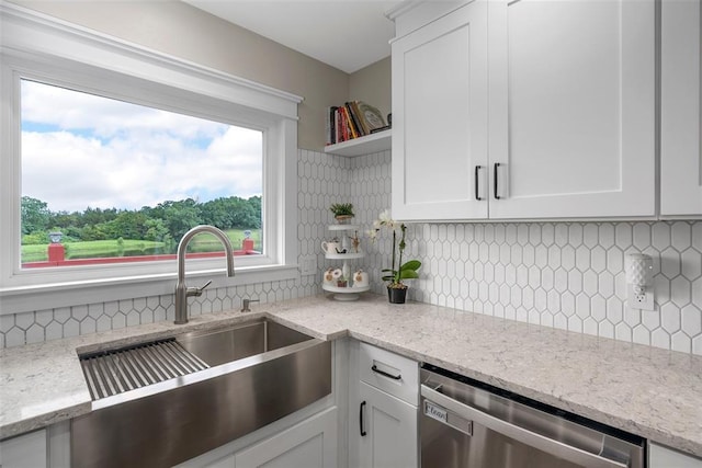 12930 Mohawk Dr, De Soto, MO 63020 - kitchen with stainless steel dishwasher, a sink, white cabinets, tasteful backsplash, and open shelves