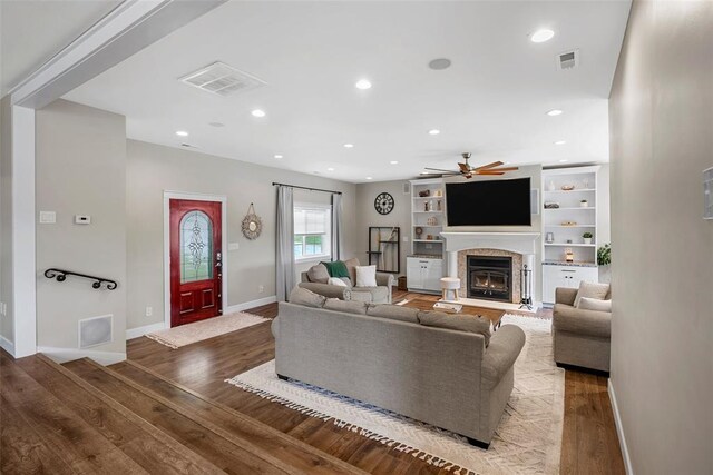 12930 Mohawk Dr, De Soto, MO 63020 - living area featuring ceiling fan, wood finished floors, a lit fireplace, baseboards, and recessed lighting