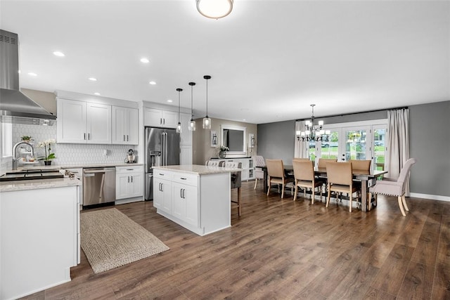 12930 Mohawk Dr, De Soto, MO 63020 - kitchen with stainless steel appliances, island range hood, dark wood-style floors, white cabinetry, and recessed lighting