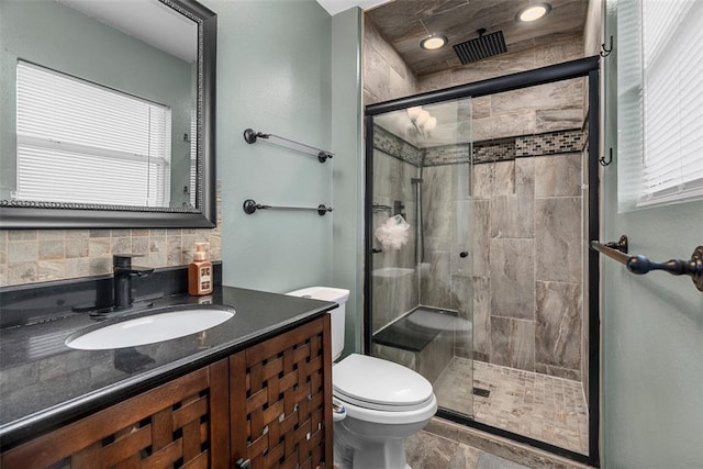 12930 Mohawk Dr, De Soto, MO 63020 - full bath featuring a shower stall, toilet, vanity, and backsplash