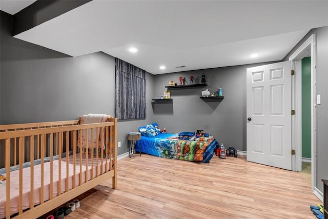 12930 Mohawk Dr, De Soto, MO 63020 - bedroom with wood finished floors, baseboards, and recessed lighting