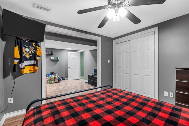 12930 Mohawk Dr, De Soto, MO 63020 - bedroom with wood finished floors, baseboards, a closet, and ceiling fan