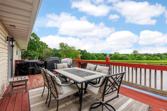 12930 Mohawk Dr, De Soto, MO 63020 - wooden deck with outdoor dining space and view of scattered trees
