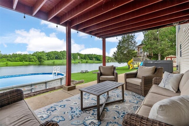 12930 Mohawk Dr, De Soto, MO 63020 - view of patio / terrace featuring an outdoor living space, a water view, an outdoor pool, and view of scattered trees