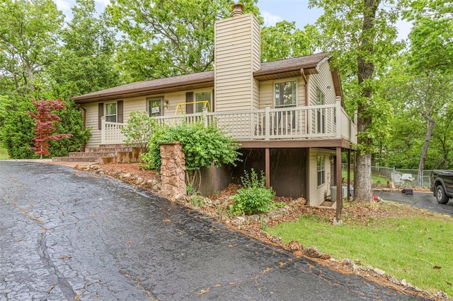 1767 Rue Andre, Bonne Terre, MO 63628 - view of front facade featuring a chimney, fence, and a wooden deck