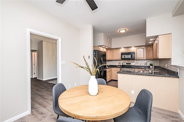 dining space with baseboards, light wood finished floors, and ceiling fan