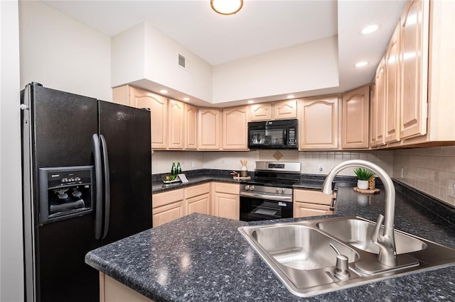kitchen featuring black appliances, a sink, light brown cabinets, dark countertops, and recessed lighting