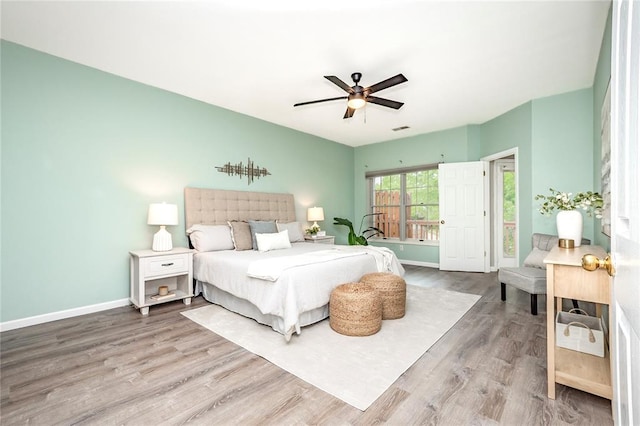 bedroom with wood finished floors, baseboards, and a ceiling fan