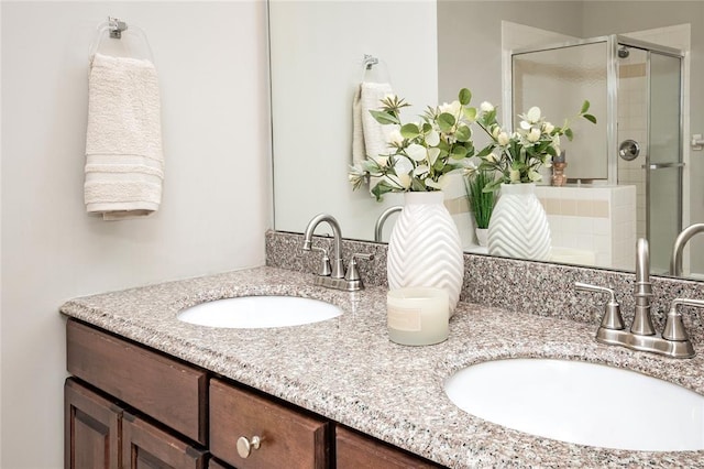 bathroom featuring a shower stall, decorative backsplash, and double vanity