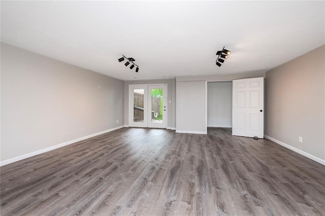 spare room with wood finished floors and baseboards