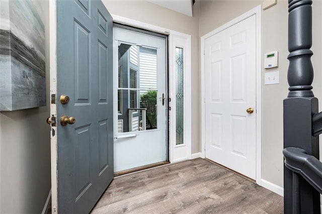 entrance foyer featuring wood finished floors and baseboards