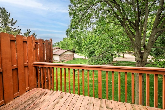 wooden deck featuring a lawn