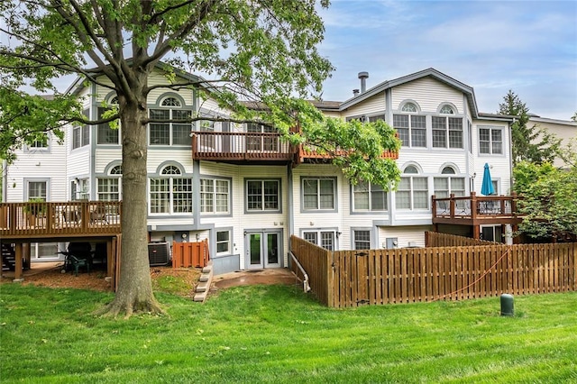 back of house with a wooden deck and cooling unit