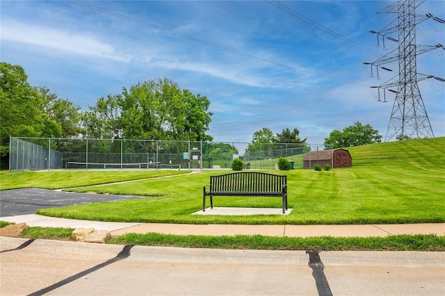 view of property's community with a tennis court